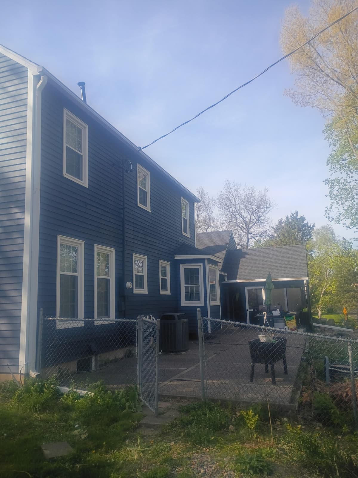 Exterior house after painting — navy blue finish by Josh's Painting