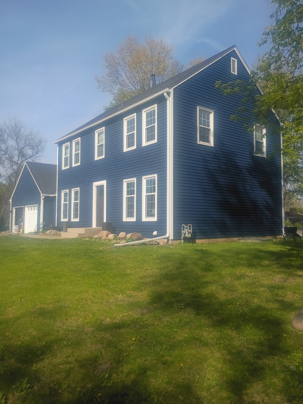 Completed exterior repaint in navy blue — Josh's Painting MN