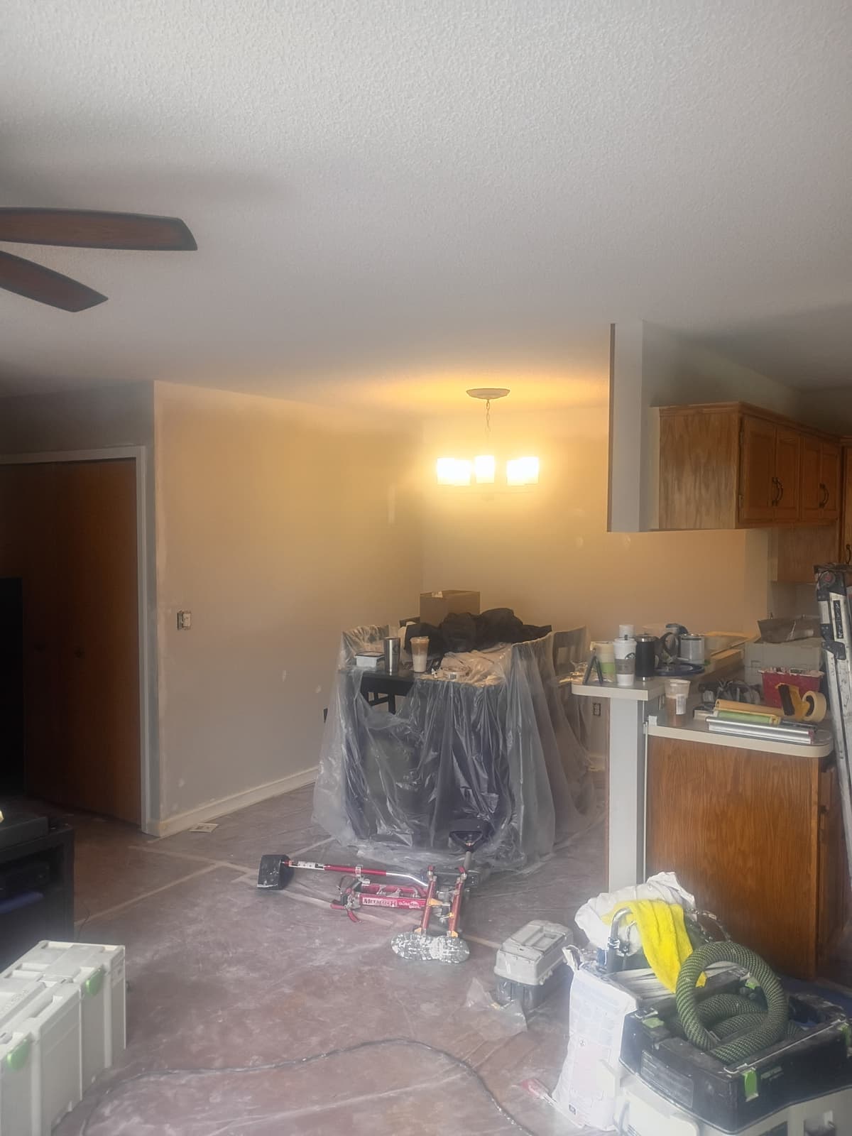 Interior painting in progress — living room covered for protection